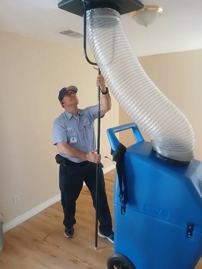 Furnace Tune-Up technician using HEPA equipment in Henderson